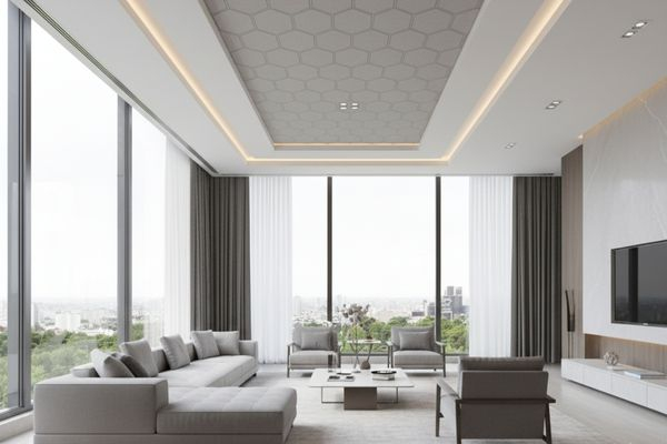 a modern, open-concept living space with a sophisticated, layered suspended ceiling with intricate, geometric patterns.