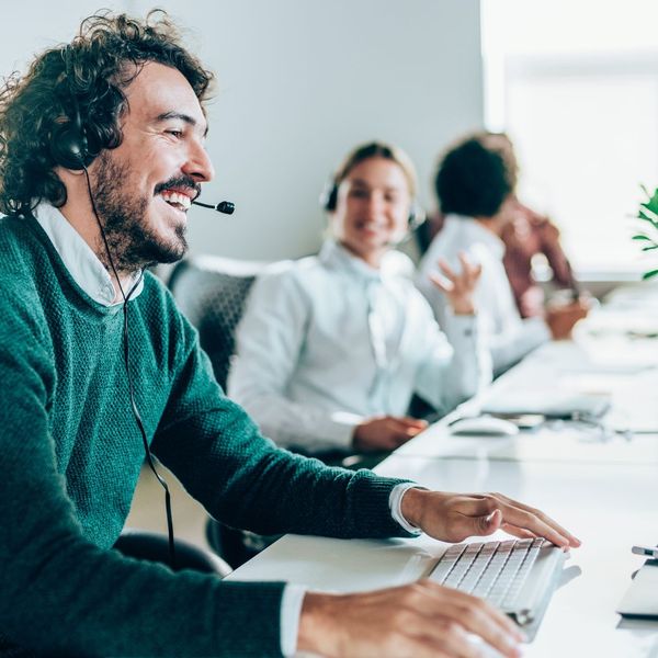 person smiling wearing headset at work