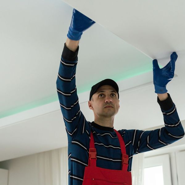 person cleaning ceiling