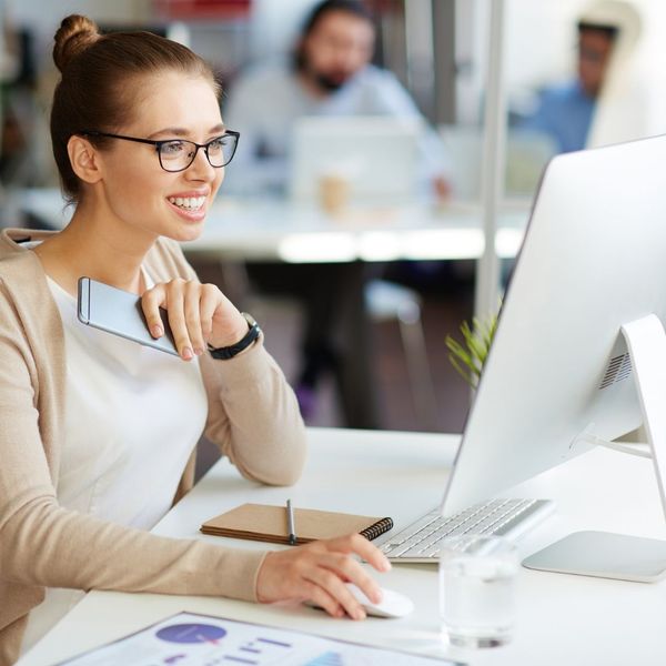 person smiling looking at a laptop