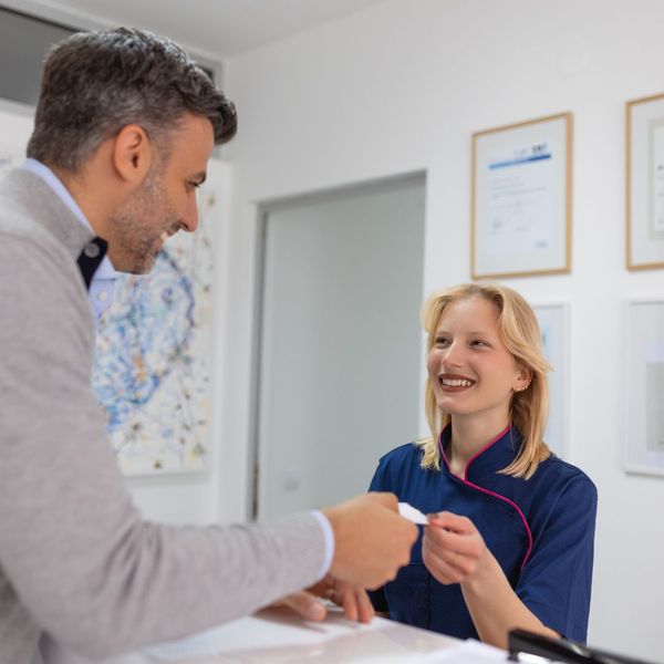 medical receptionist speaking to patient