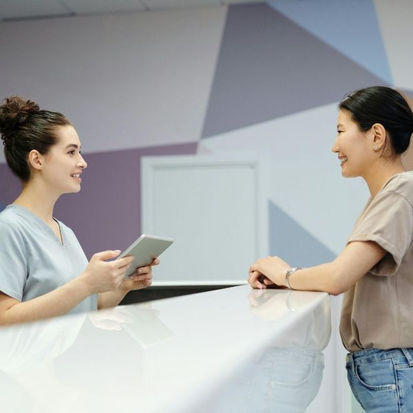 medical receptionist speaking to patient