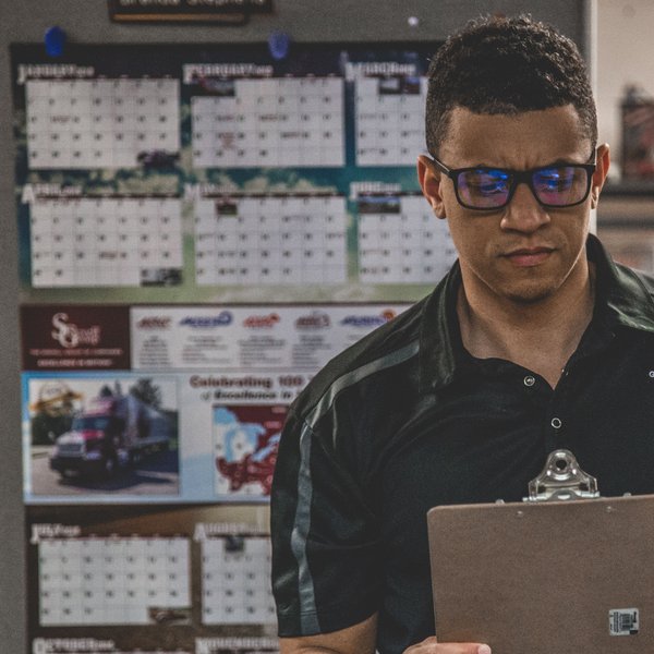 Person Looking at a clipboard Person Looking at a clipboard