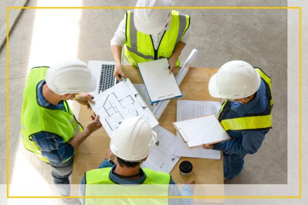 Team of general contractors looking at plans