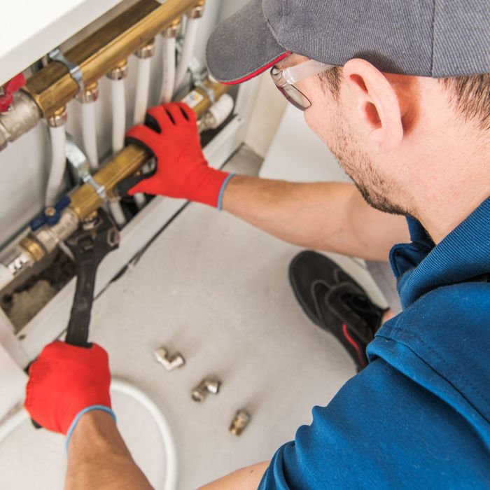 plumber installing pipe lining