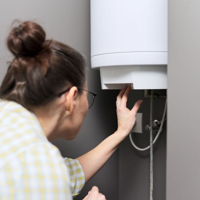 person examining water heater