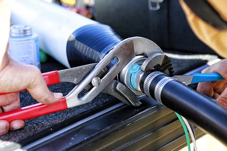 photo of person working on pipe fittings