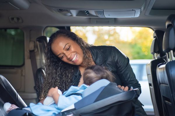 woman smiles with baby in car seat Garage Door Opener Repair 3.jpg
