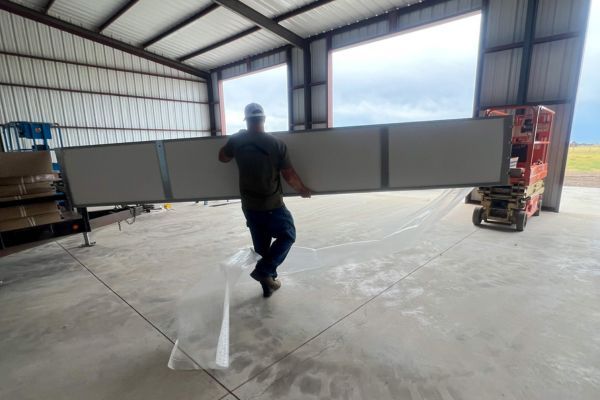 man carries garage door panel Panel Replacement 3.jpg