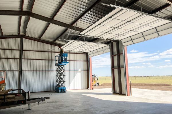 large metal building with garage doors open Garage Door Opener Repair 1.jpg