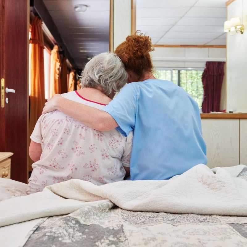 a woman comforting an elder woman