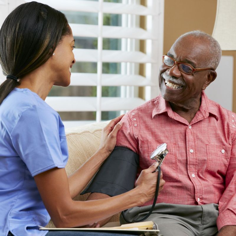 nurse checking a mans blood pressure