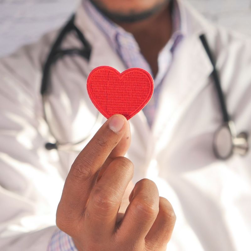 doctor holding a heart sticker
