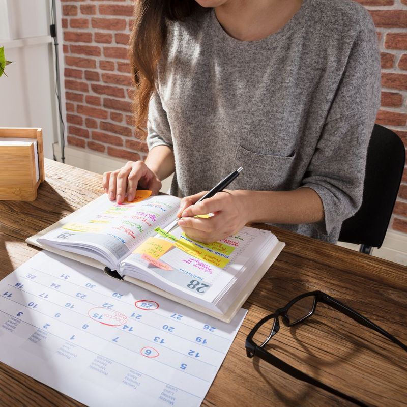 a person writing in a planner