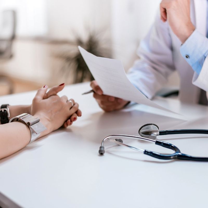 person sitting with a doctor