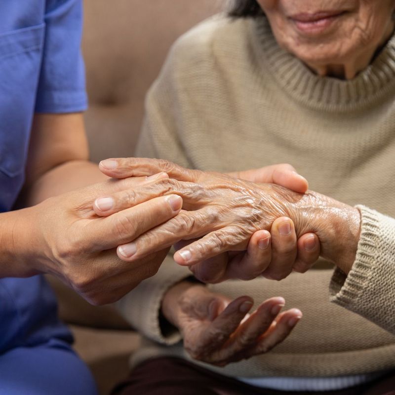 person holding an older persons hand