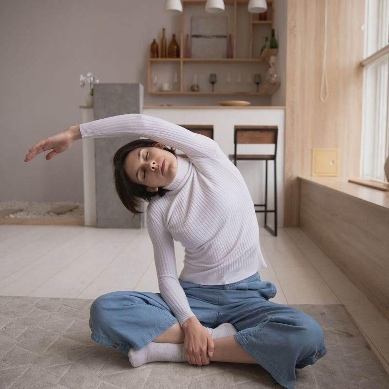 a woman stretching in her home