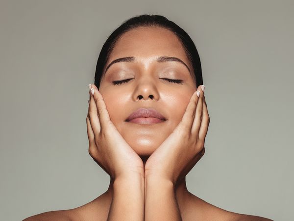 Image of a woman holding her chin