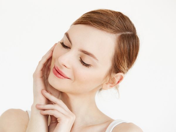 Image of a woman touching her face