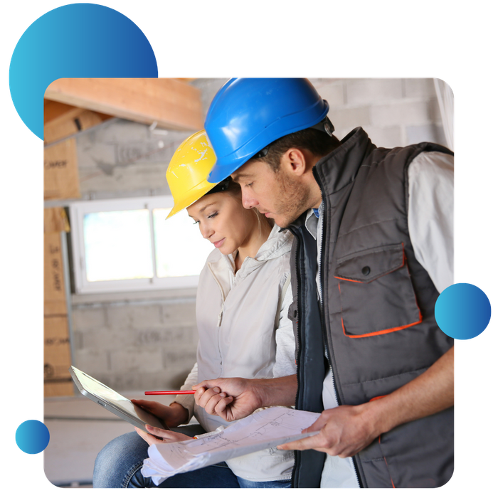 worker with hard hats looking at tablet