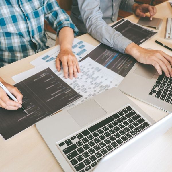 People working on laptops next to each other