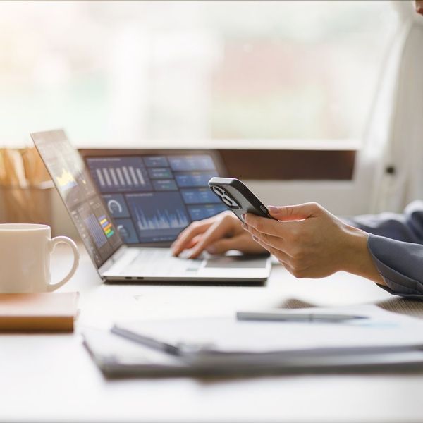 Person working on multiple screens