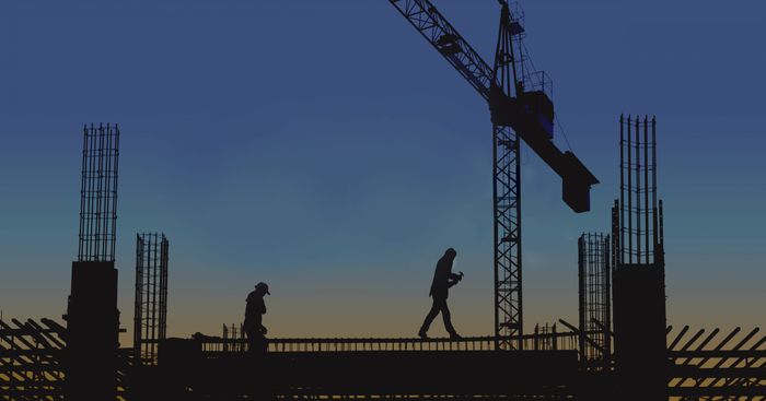 Silhouette of construction site at dusk