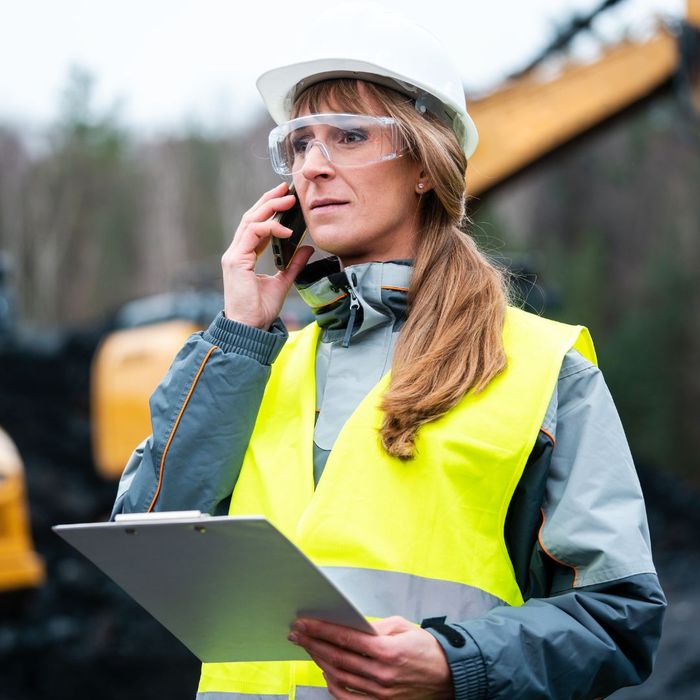 Woman construction worker on the phone