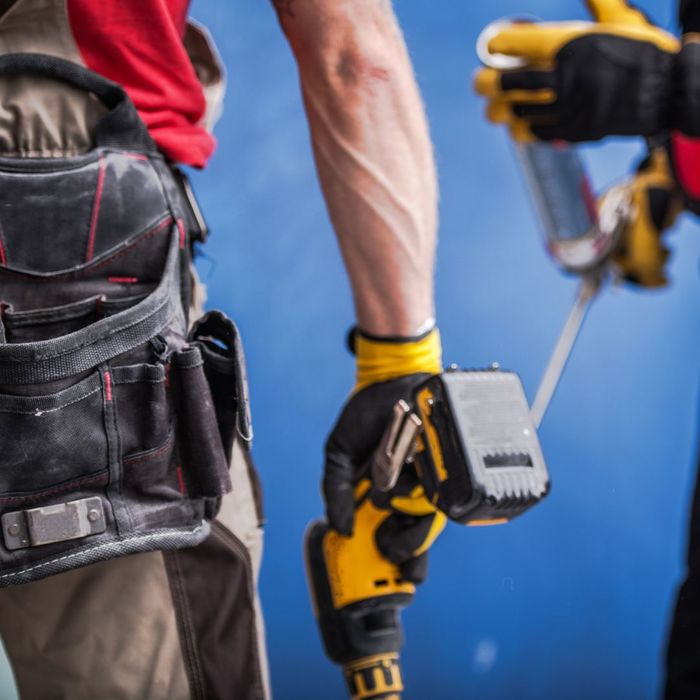 construction worker holding drill construction worker holding drill