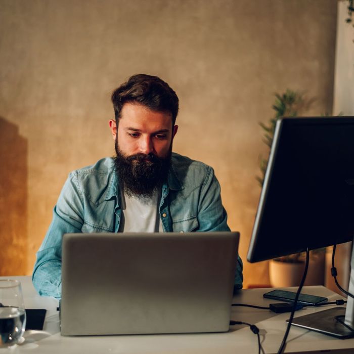 Person working on multiple screens