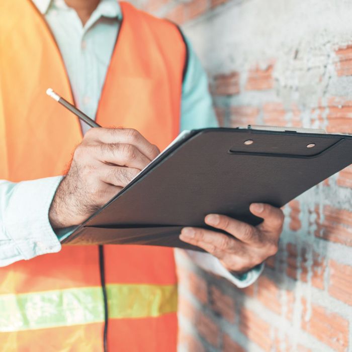 construction worker holding clip board