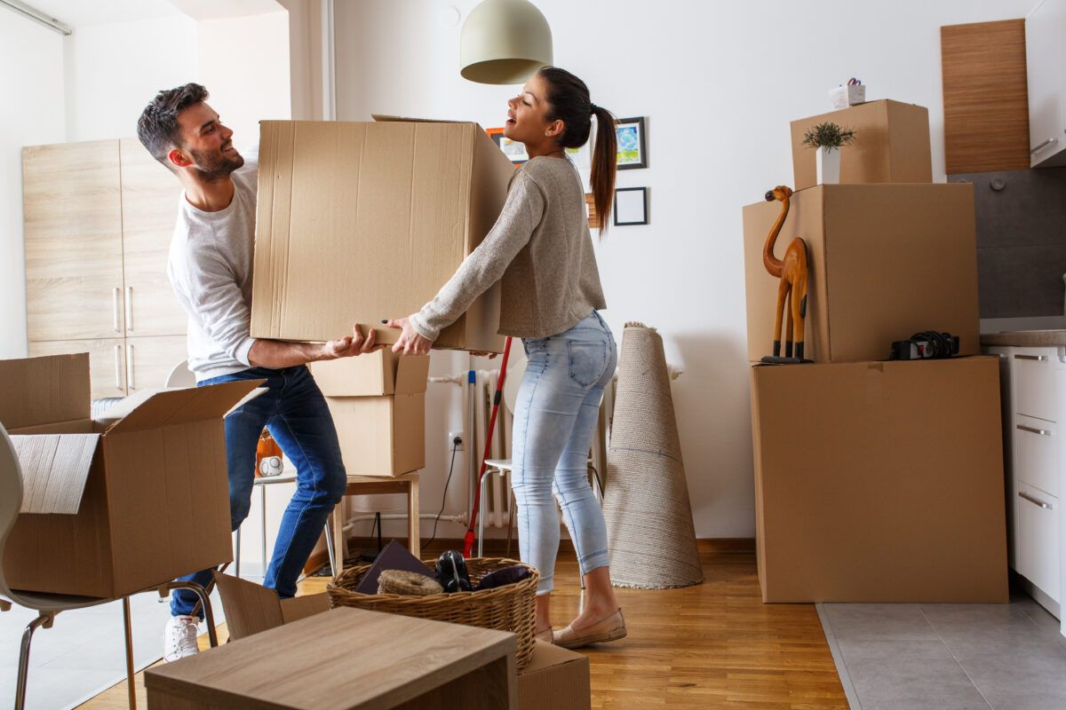 couple moving box together