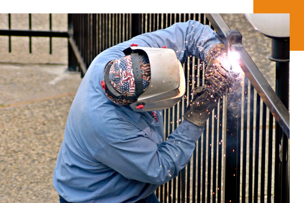 Welder fixing a fence