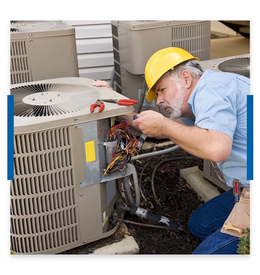 Man working on an air conditioner.