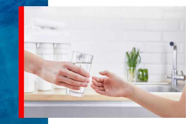 Man handing woman a clear glass of water