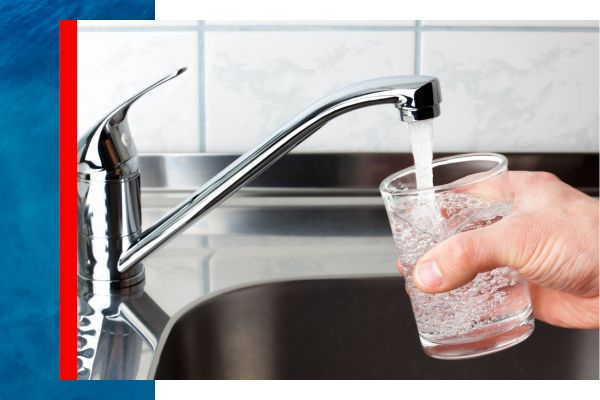 Clean water coming out of a faucet into a glass