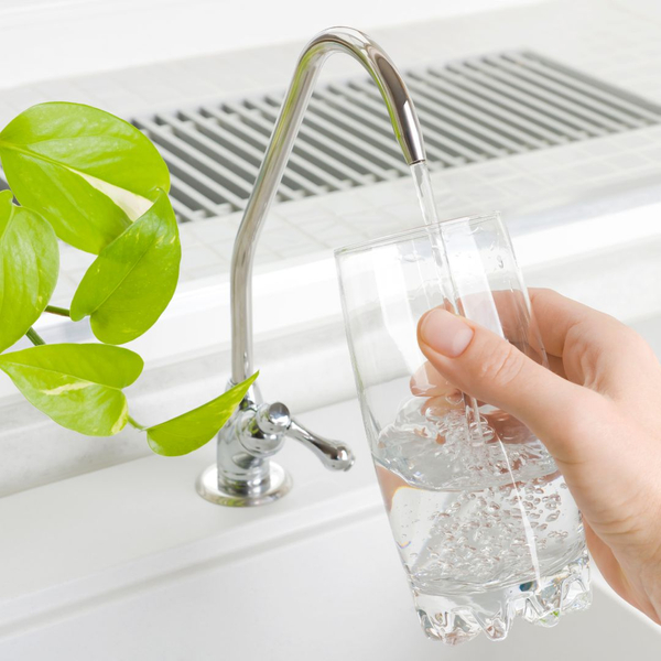 filling glass of water from sink tap