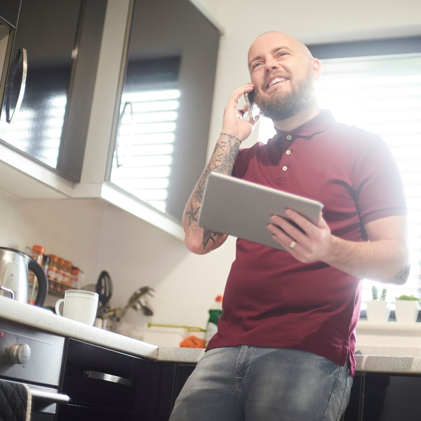 happy homeowner on phone