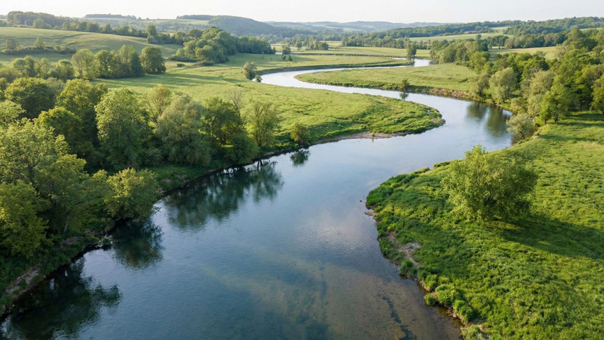 winding river flowing through a natural landscape winding river flowing through a natural landscape