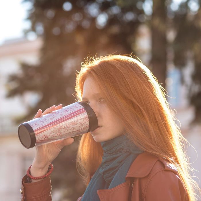 Woman enjoying her coffee on the go