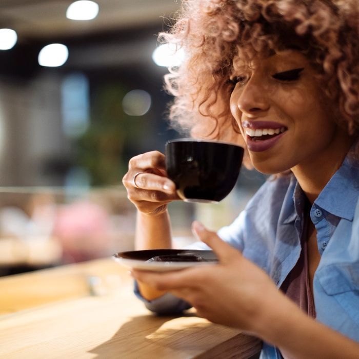 woman about to take sip of coffee