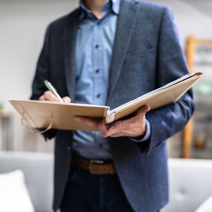 man writing in folio