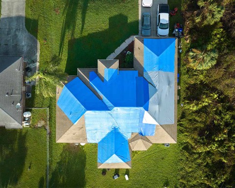 aerial view of roof with tarps on top