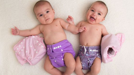 two babies with cloth diapers