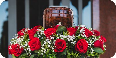 urn surrounded with roses