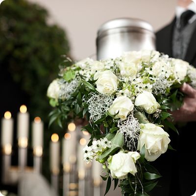 carrying metal urn and white roses