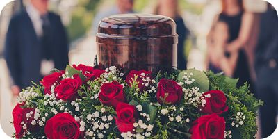 urn surrounded with roses