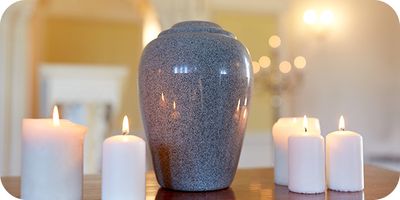 tall urn on table with candles