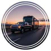 Black truck carrying a mobile home on the highway