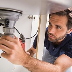 Plumber Fixing a Sink